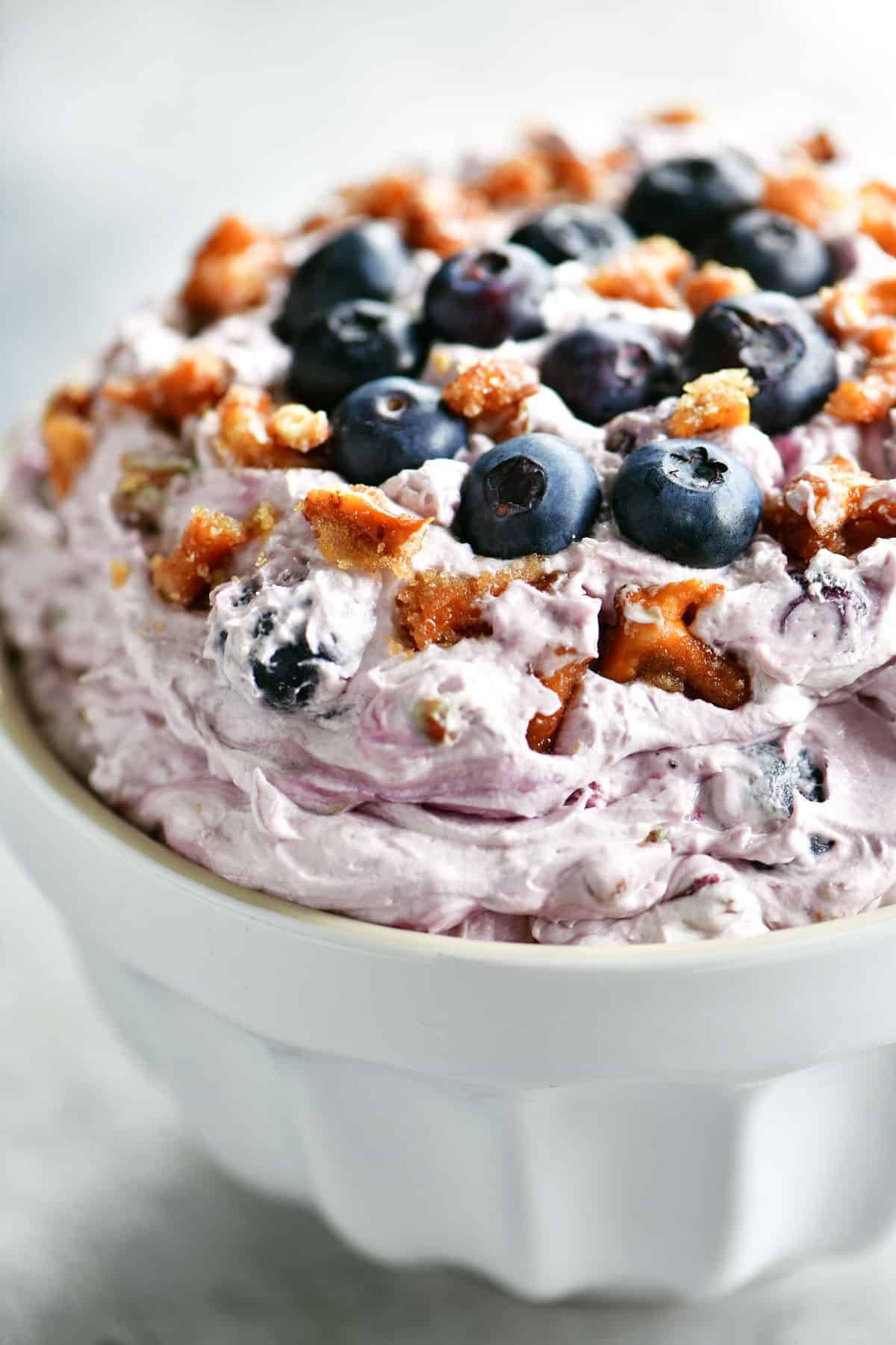 blueberry pretzel salad in a white bowl