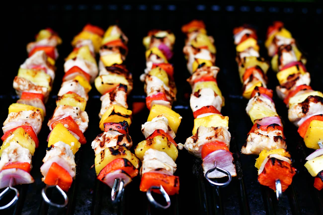 mango chicken kabobs cooking on the grill