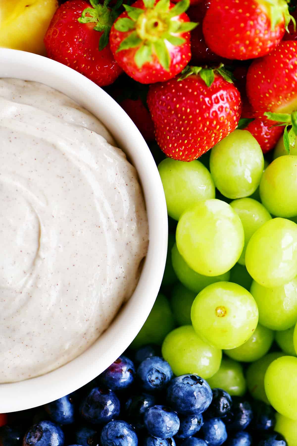 fruit dips in a bowl with grapes, blueberries and strawberries