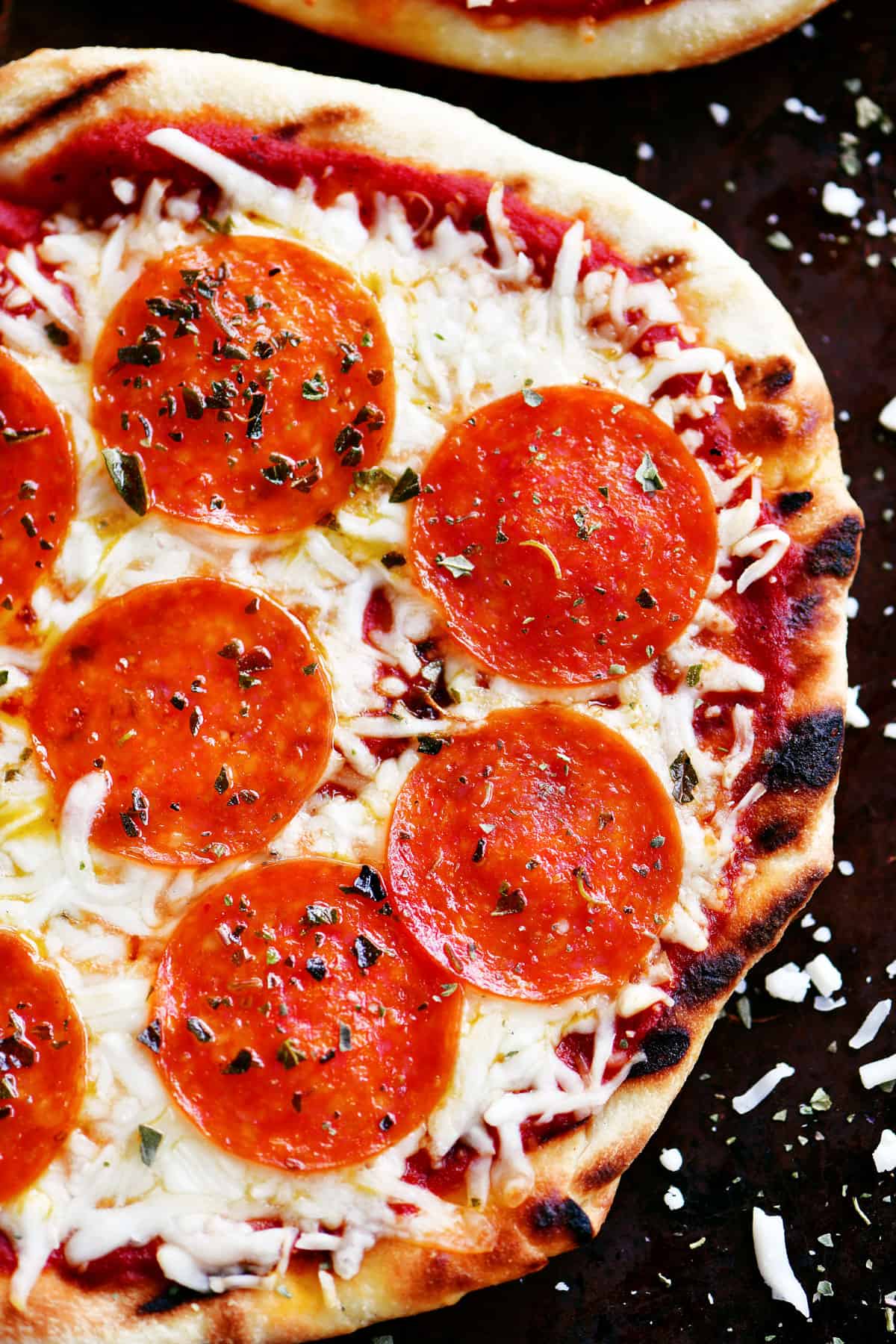 A grilled pizza with pepperoni on top.