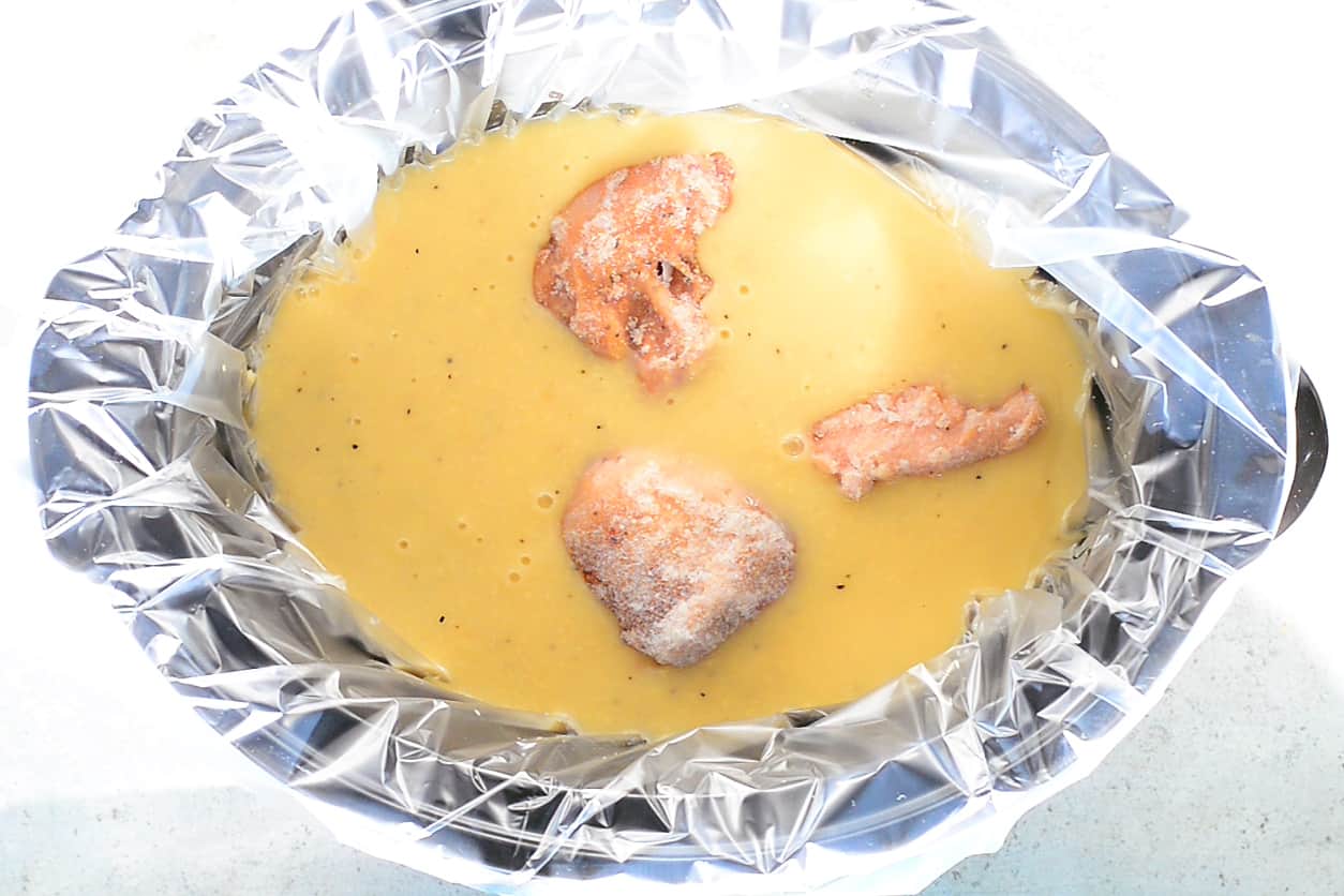 raw chicken breast in soup mixture
