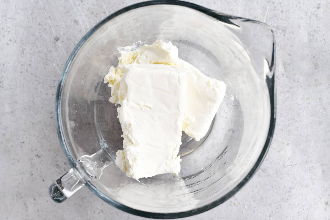 two blocks of cream cheese in a bowl