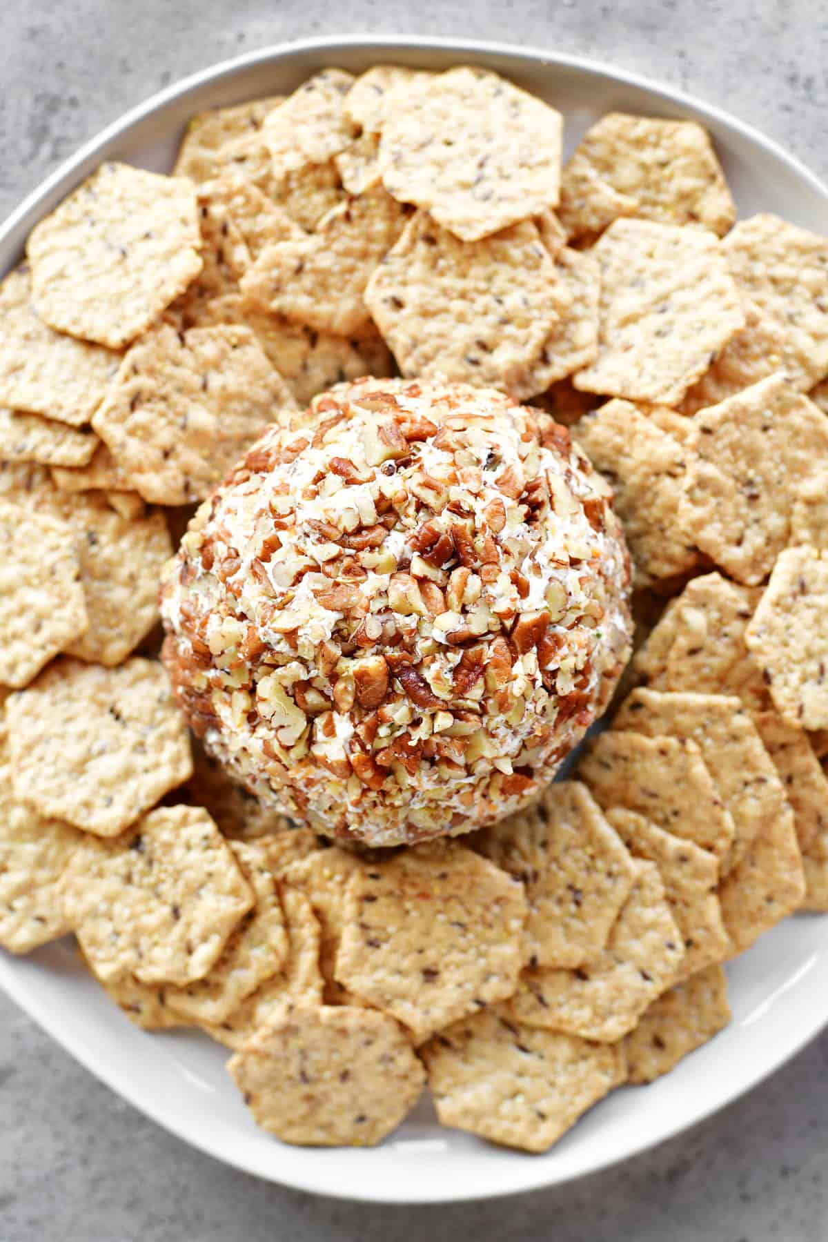 cheese ball on a platter with crackers