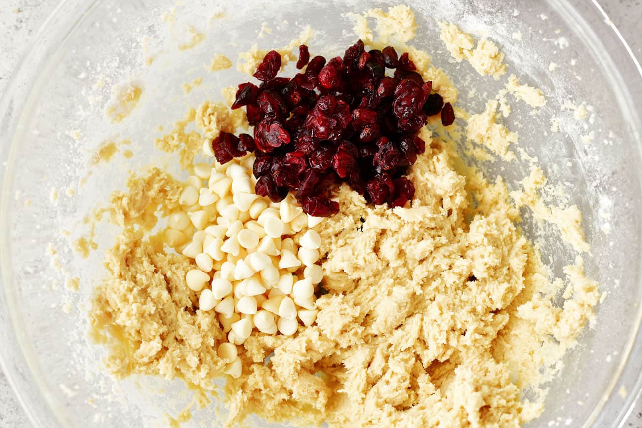 white chocolate chips and dried cranberries added to bowl