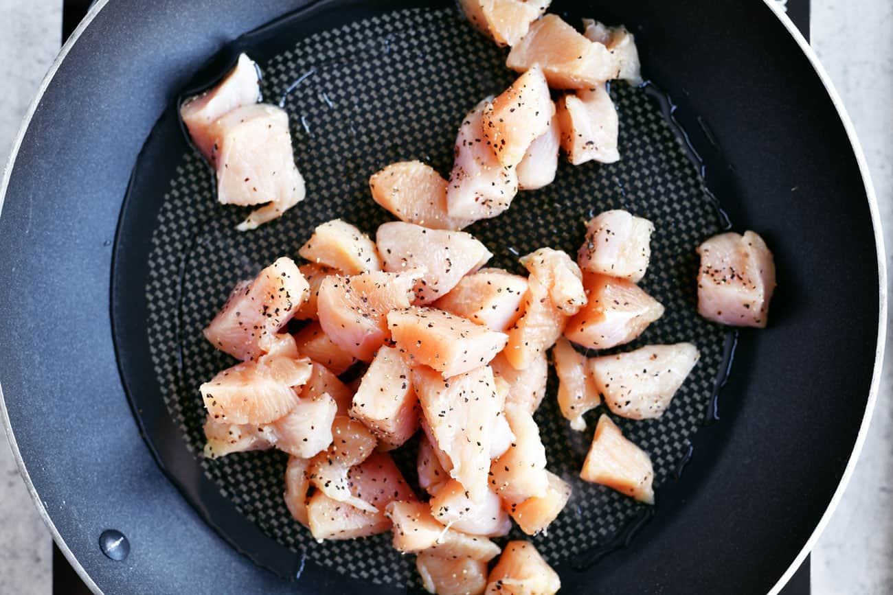 cubed chicken breast in frying pan