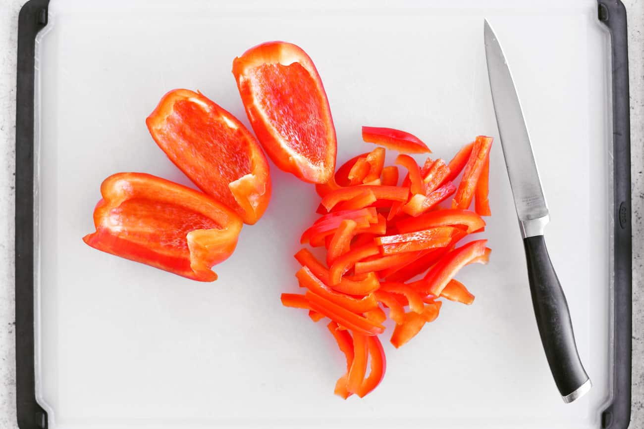 sliced red peppers on a cutting board