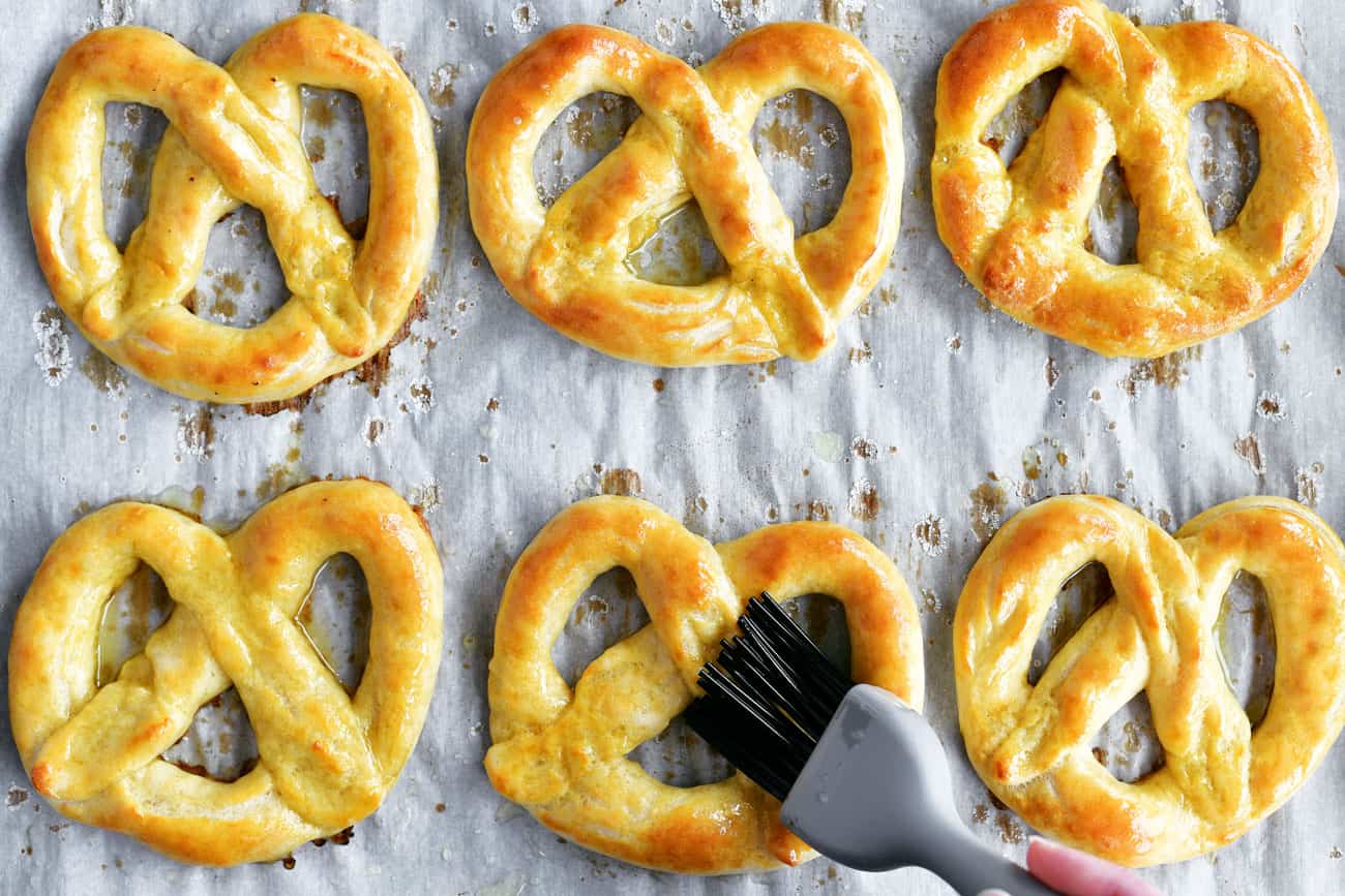 brushing soft pretzels with melted butter