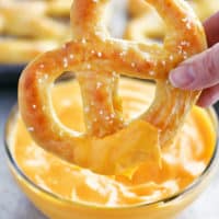 soft pretzel dipped in cheese sauce