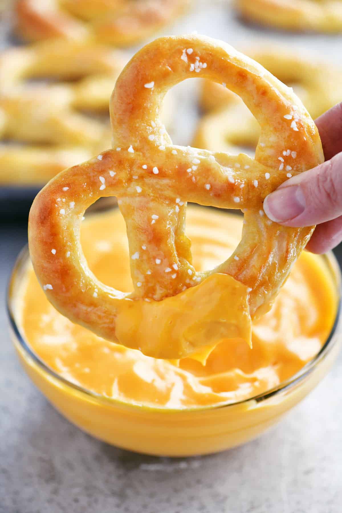 soft pretzel dipped in cheese sauce