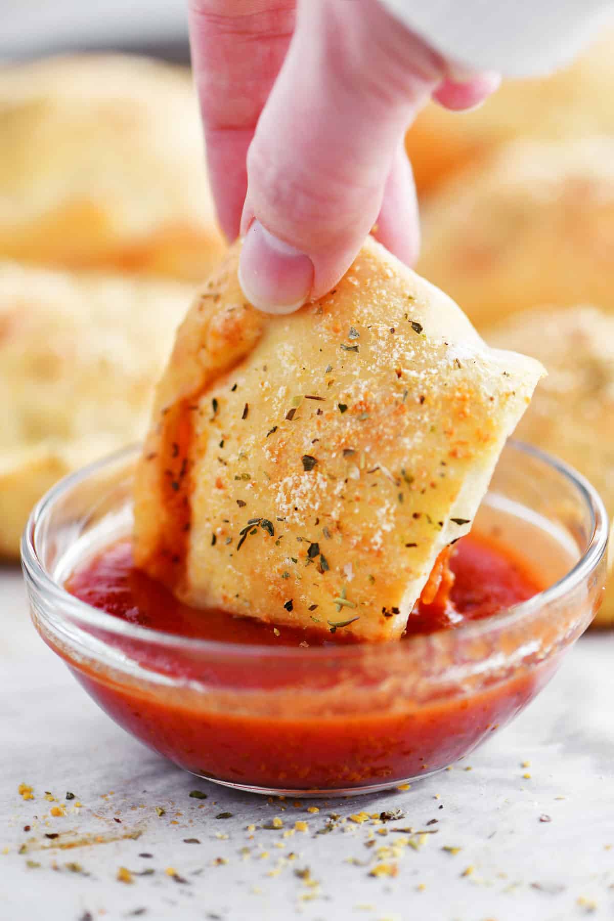 dipping calzone in pizza sauce