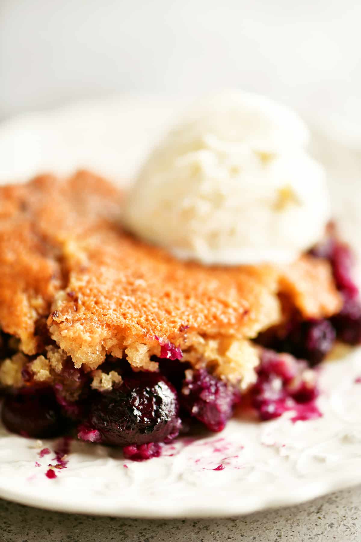 slice of blueberry cobbler with ice cream on top
