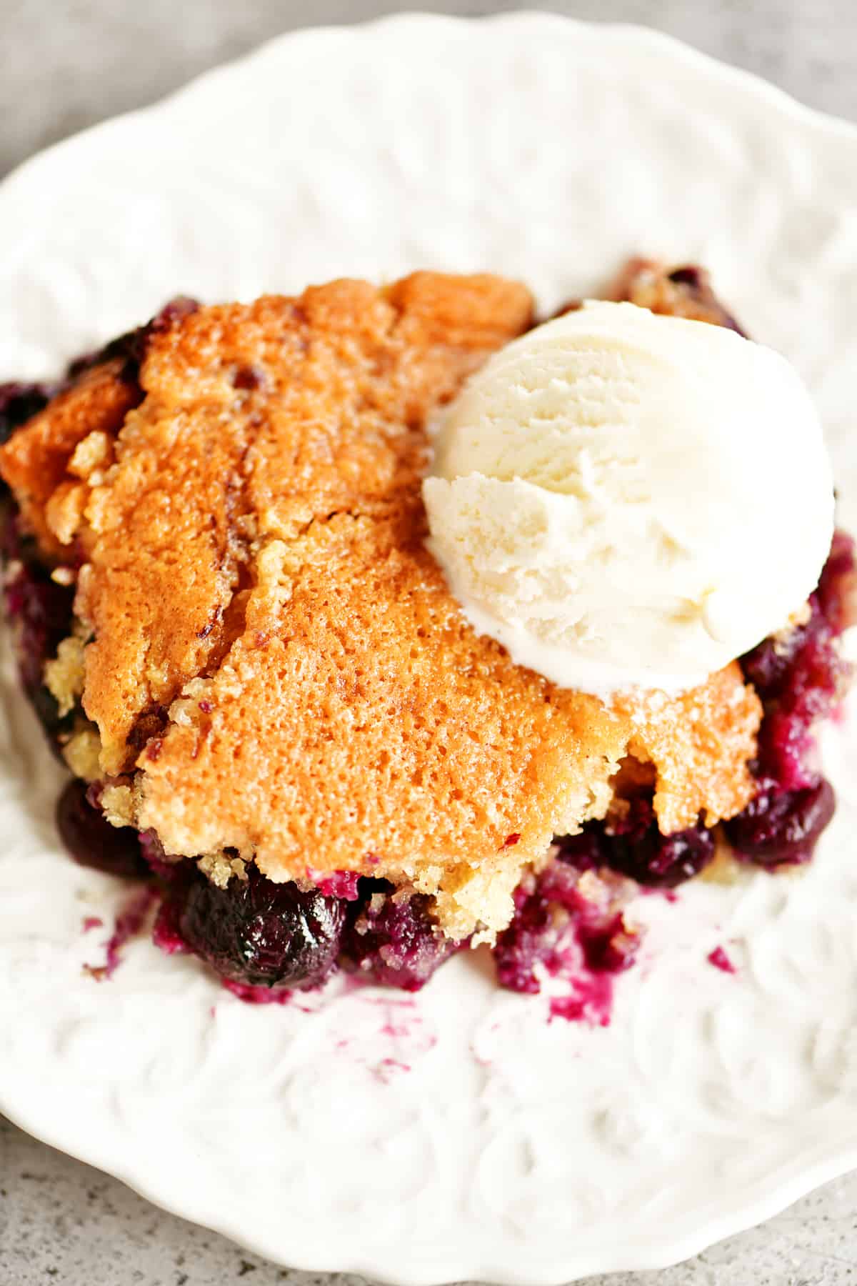slice of blueberry cobbler with ice cream on top
