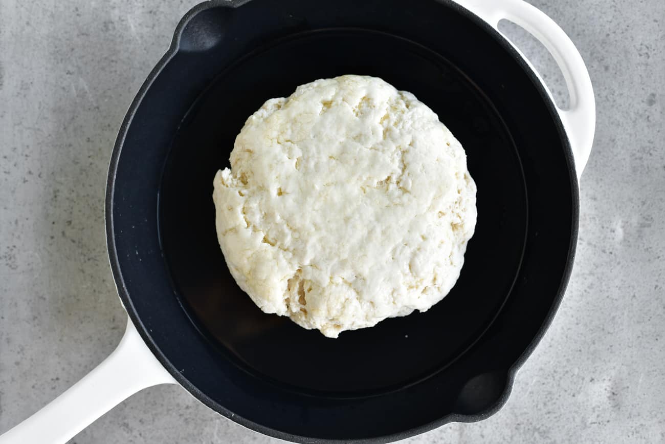 ball of dough in cast iron skillet