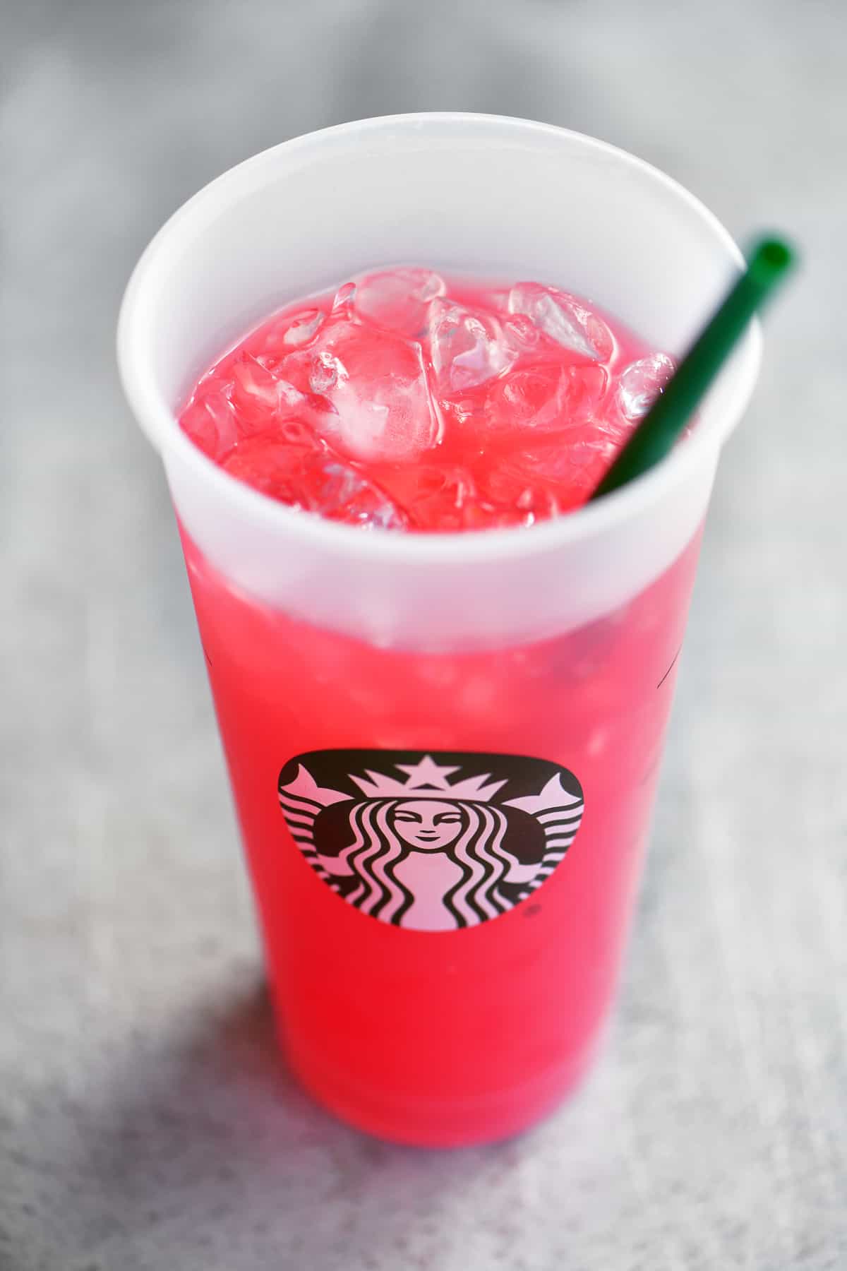 passion tea lemonade in a starbucks cup with straw