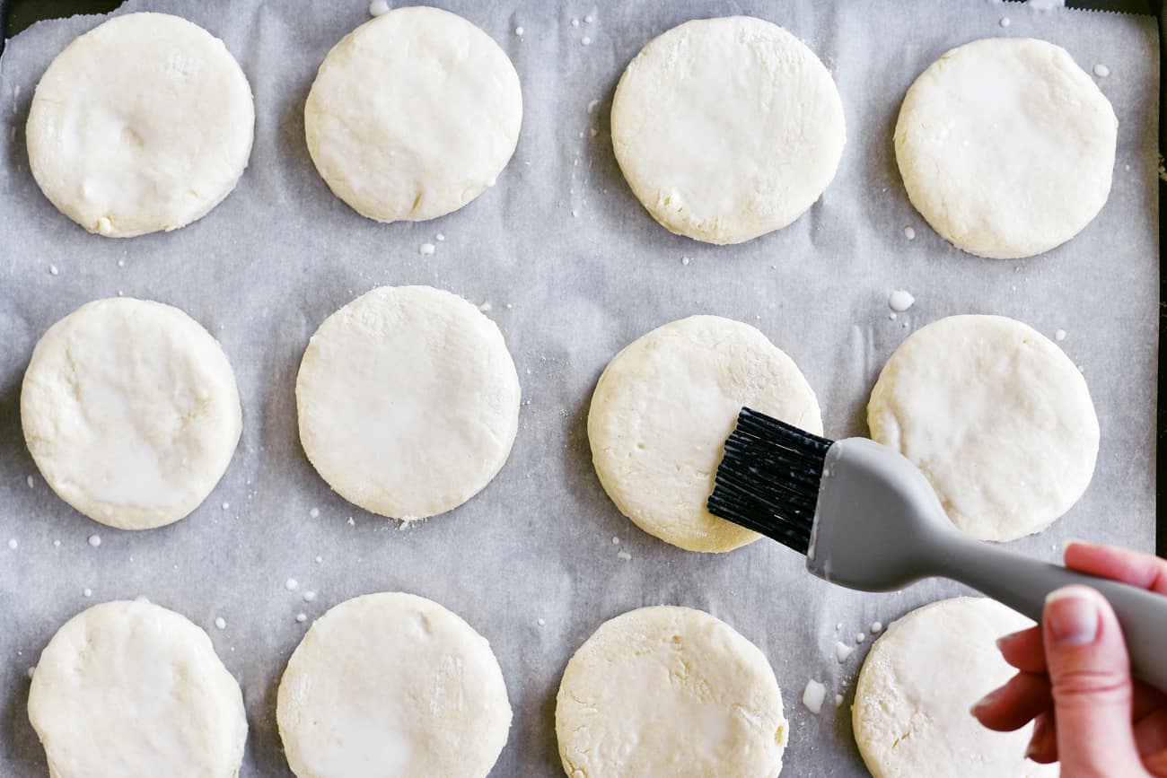 brushing biscuits with buttermilk