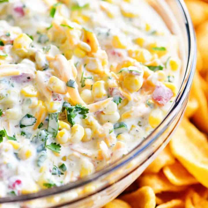 corn dip in a bowl surrounded by fritos