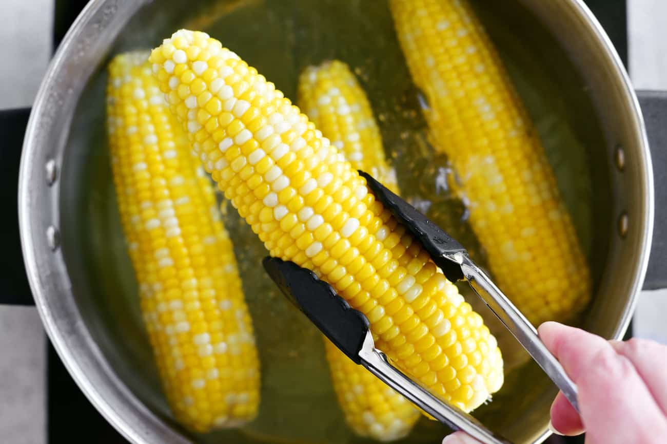 corn cob in tongs