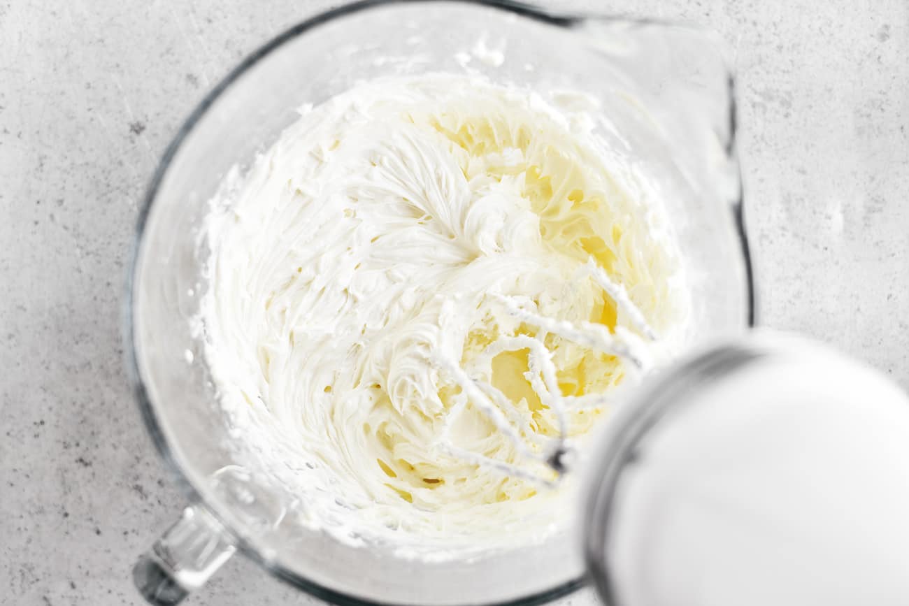 beating cream cheese in bowl