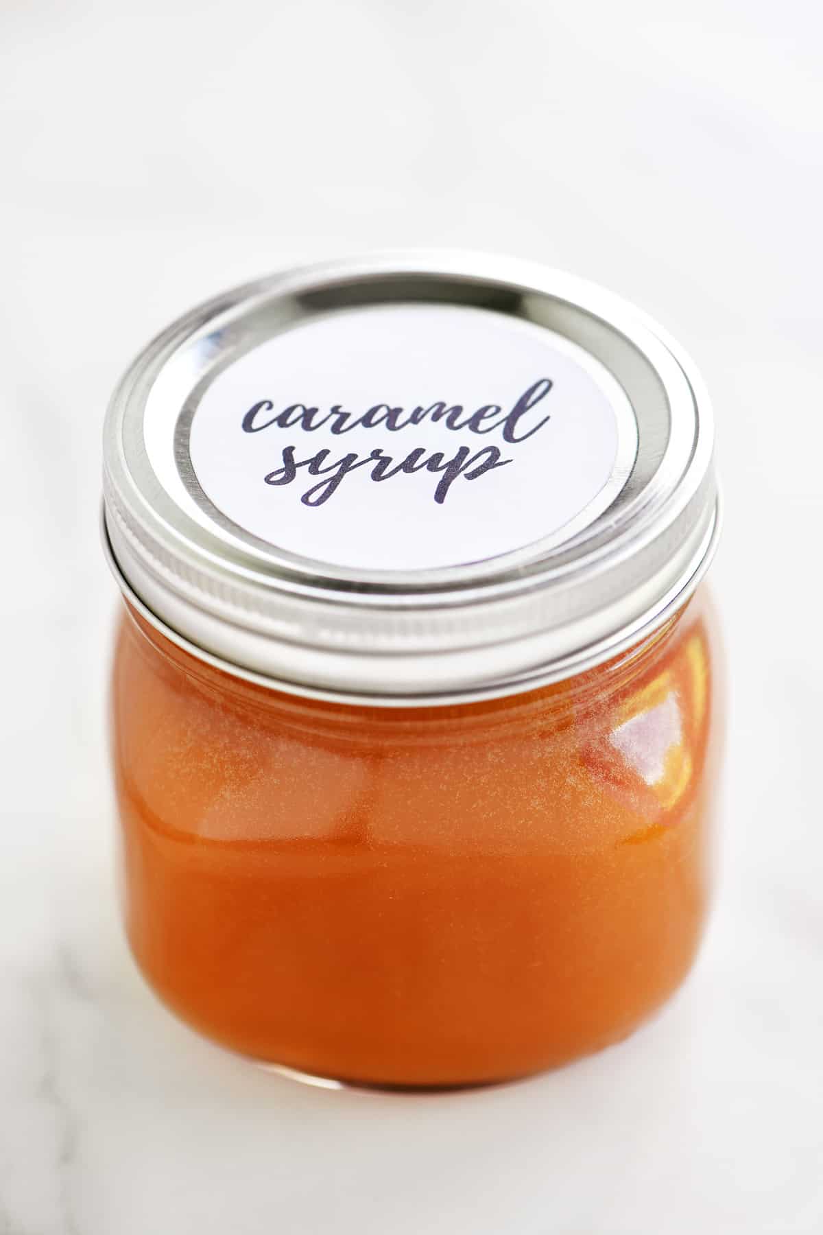 side view of mason jar of caramel syrup
