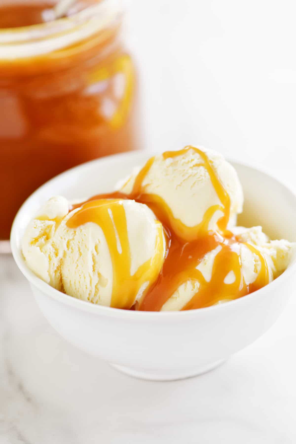 vanilla ice cream with caramel on top in a bowl