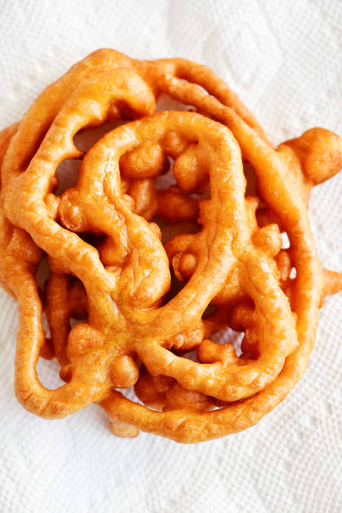 funnel cake draining on paper towels