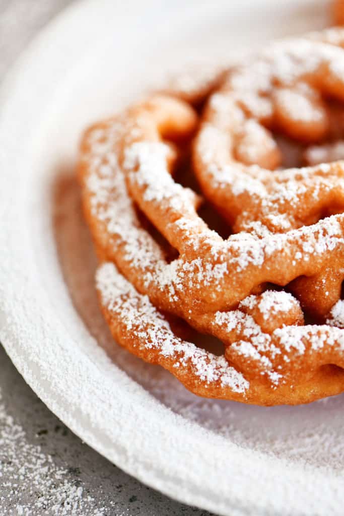 close up funnel cake with powdered sugar