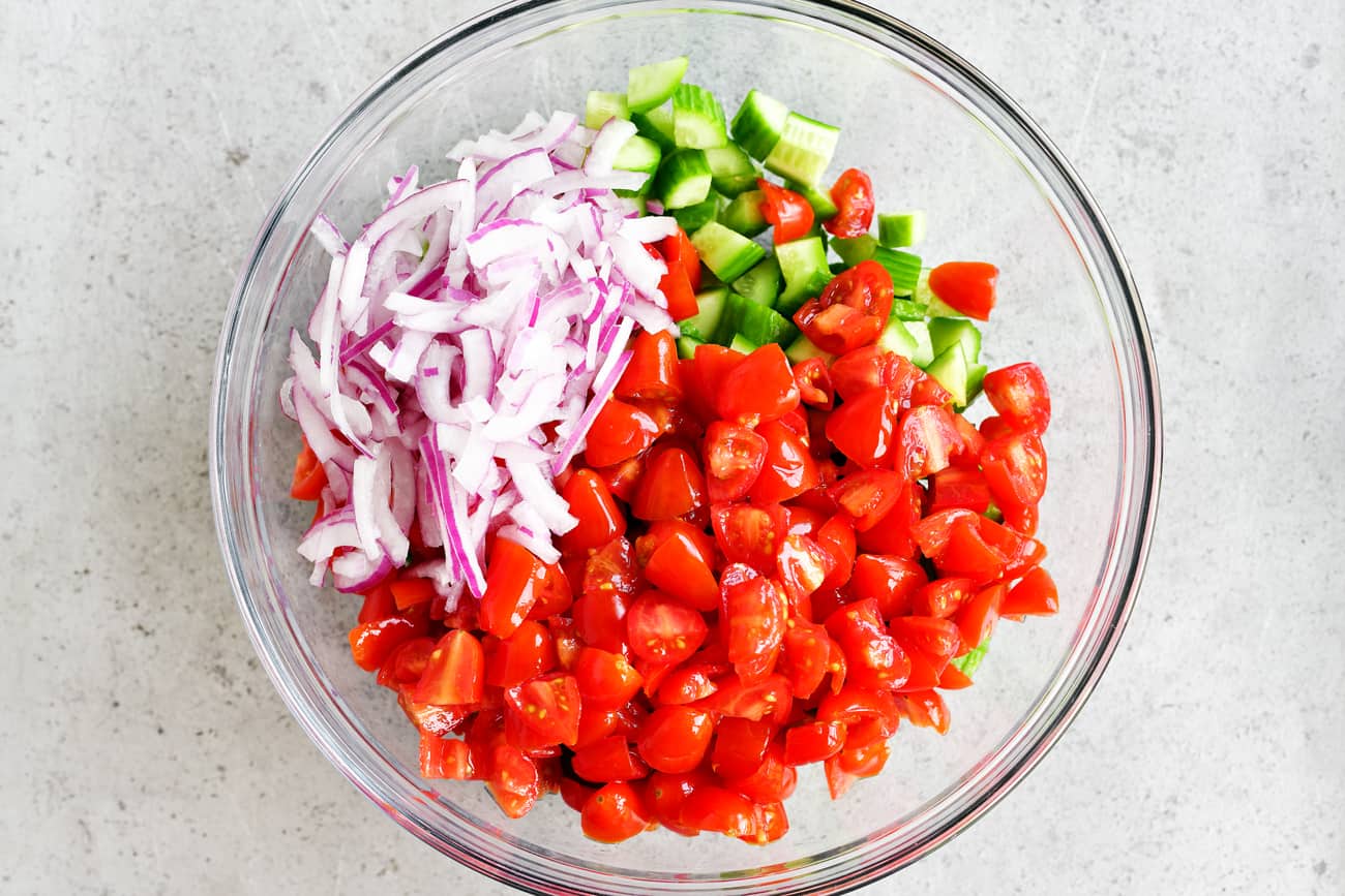 bowl with sliced onions, tomatoes and cucumbers