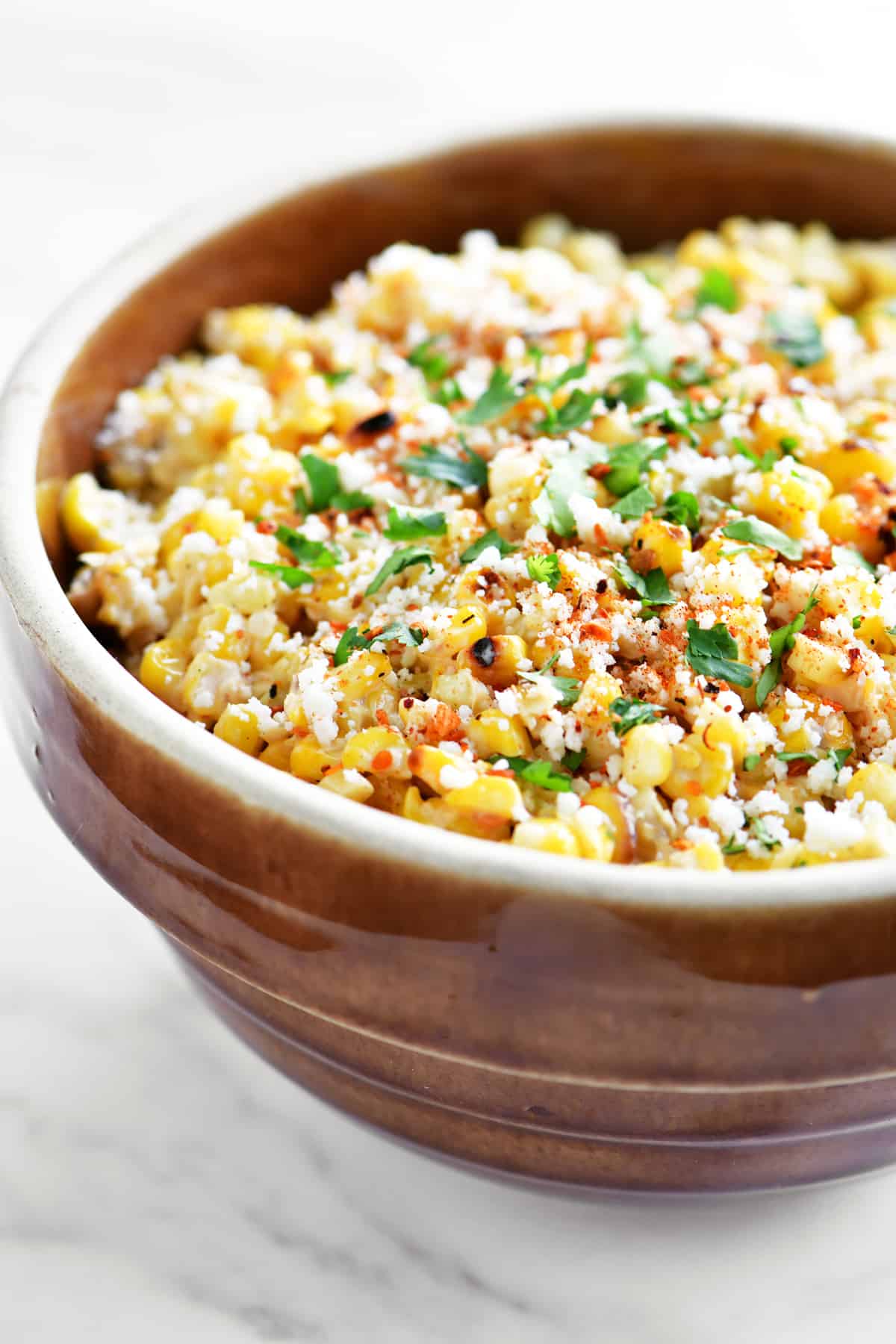 mexican street corn salad in a brown bowl