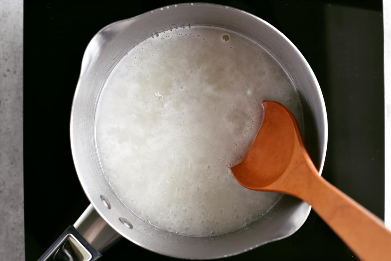 stirring simple syrup in a saucepan
