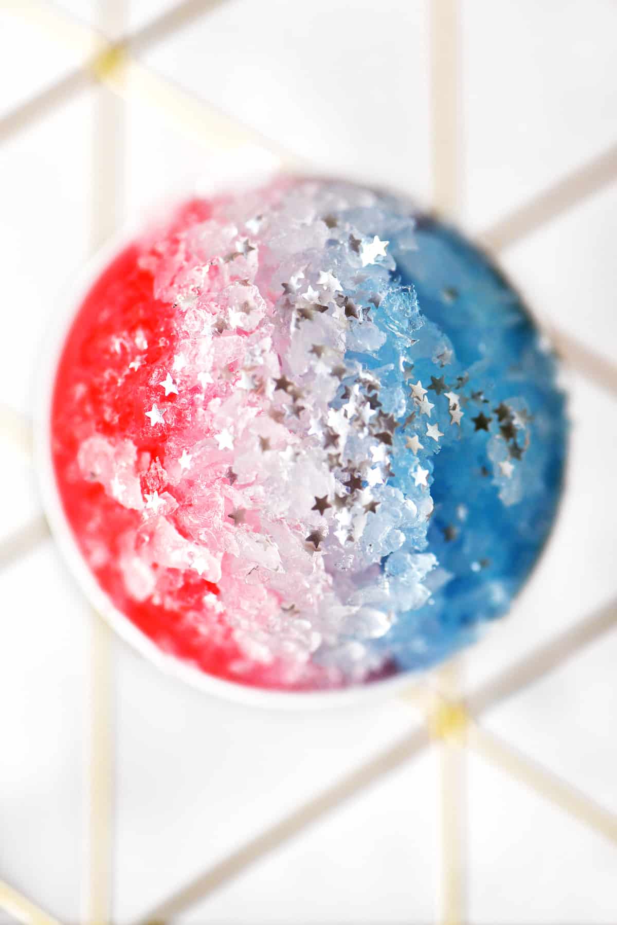 a red, white and blue ice with edible silver star sprinkles on top