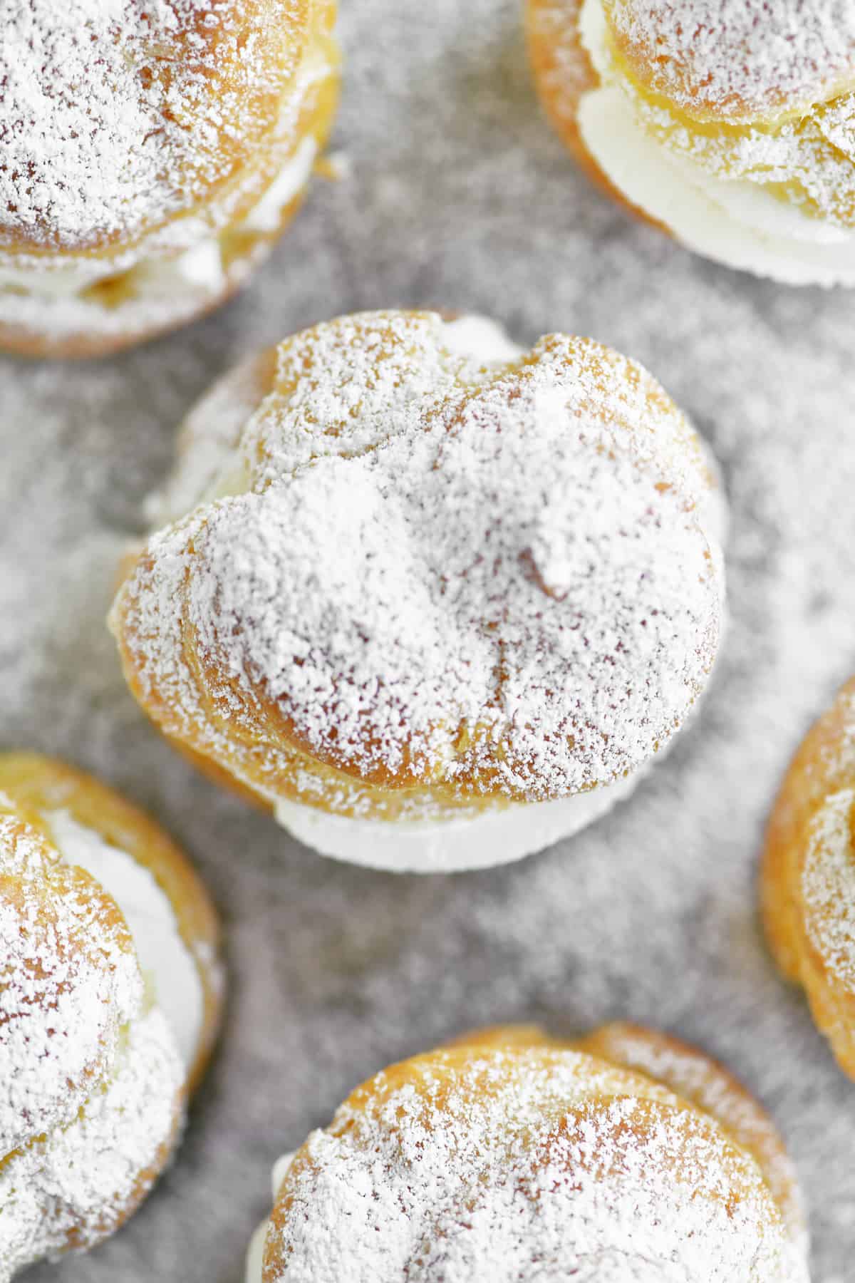 a topdown view of cream puffs on a pan
