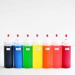 row of colorful filled squeeze bottles