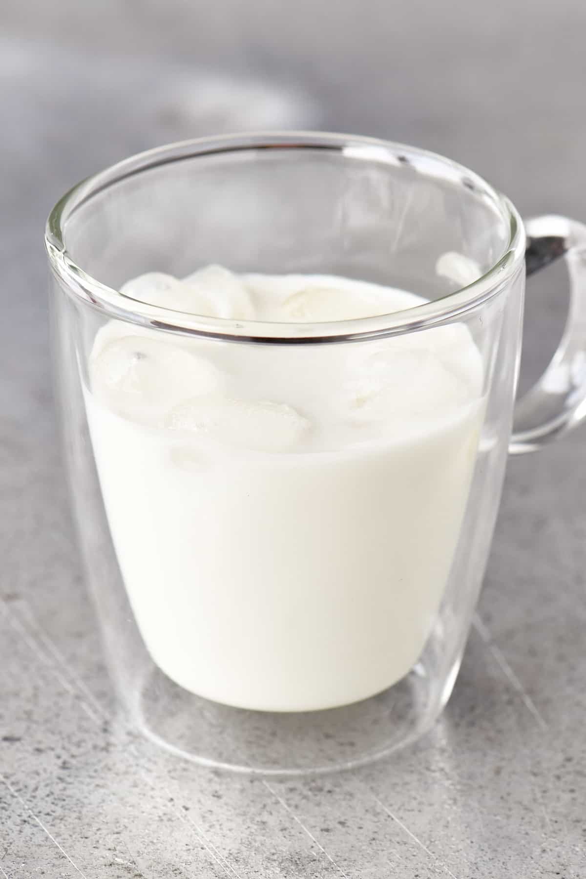 clear glass mug with milk and ice