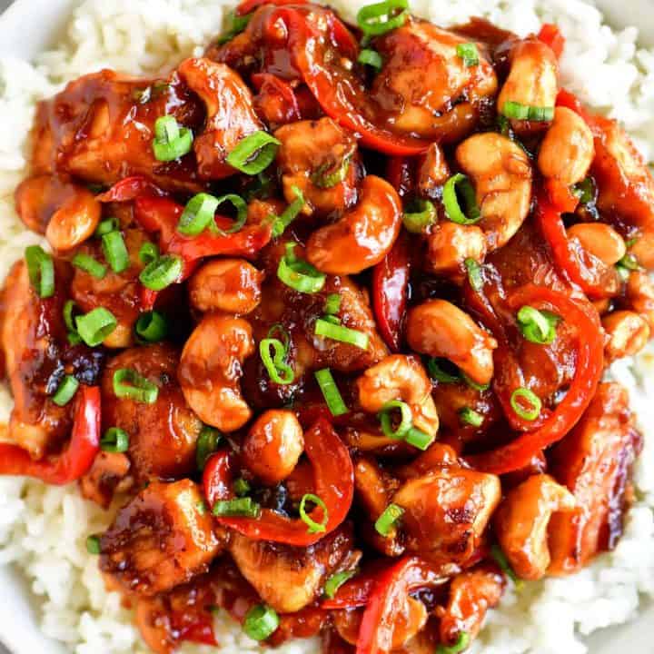 white bowl with cashew chicken on top of rice
