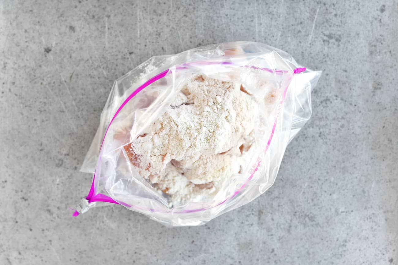 flour on cubed chicken in plastic ziptop bag