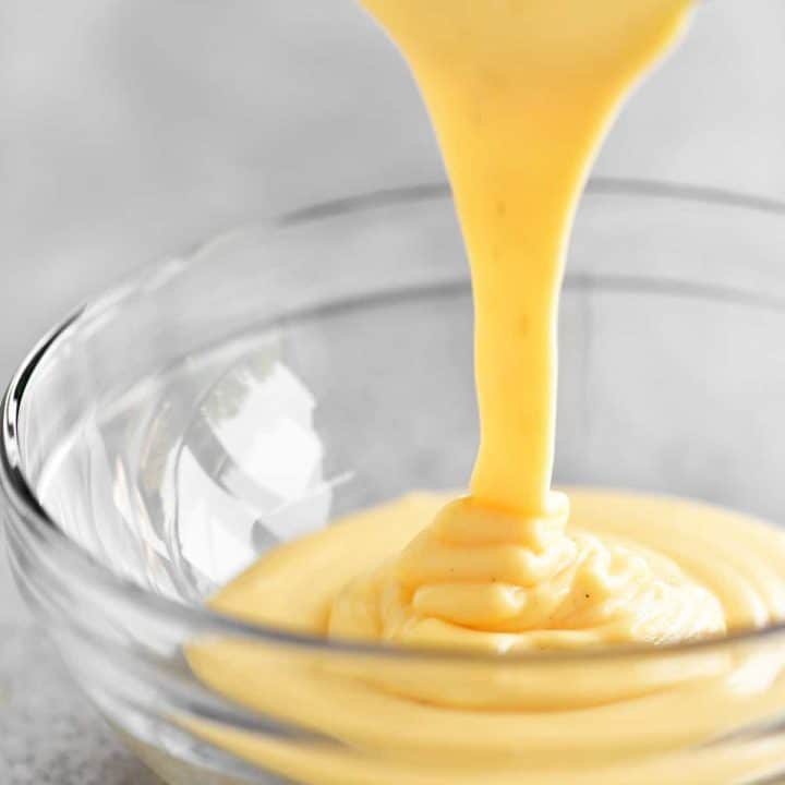 pouring the cheese sauce into a glass bowl