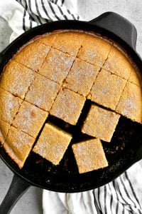 a topdown shot of sliced cornbread in the pan