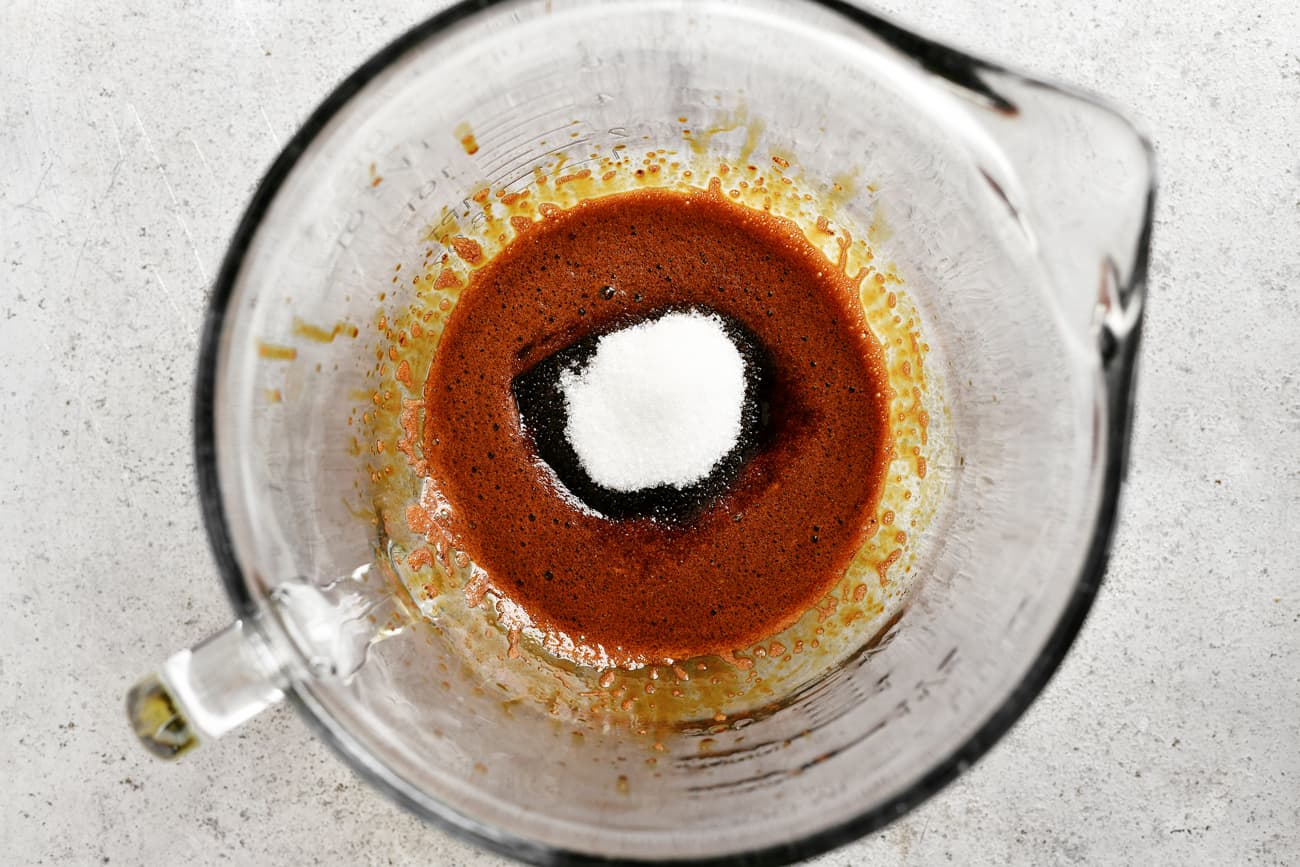 adding granulated sugar to the instant coffee mixture