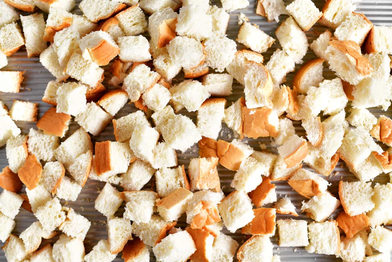 a photo of bread cubes on a baking pan