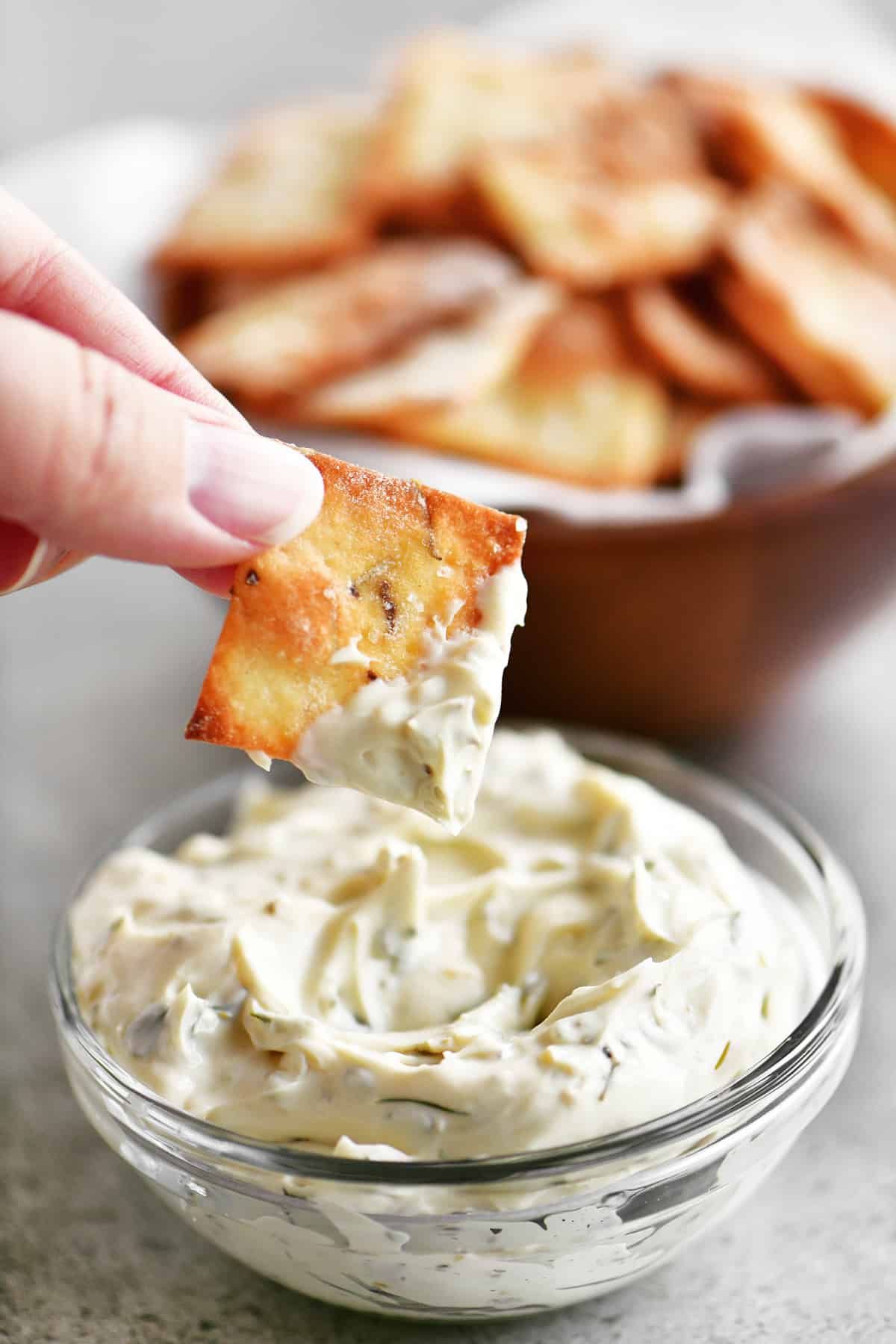 dipping a cracker in dip