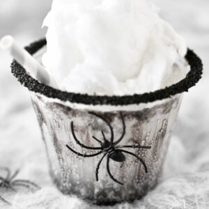 A black spider on a Halloween drink for kids.