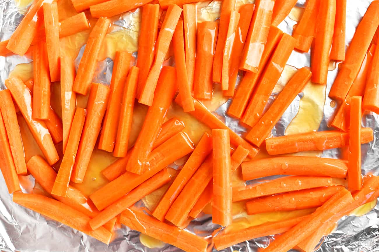 coating the carrots with a honey-butter glaze prior to roasting