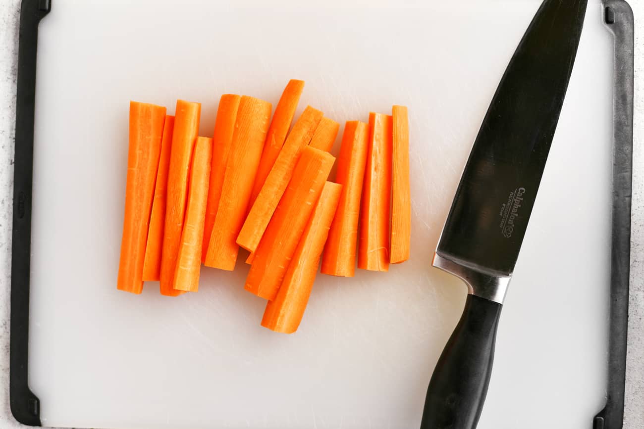 cutting the peeled carrots