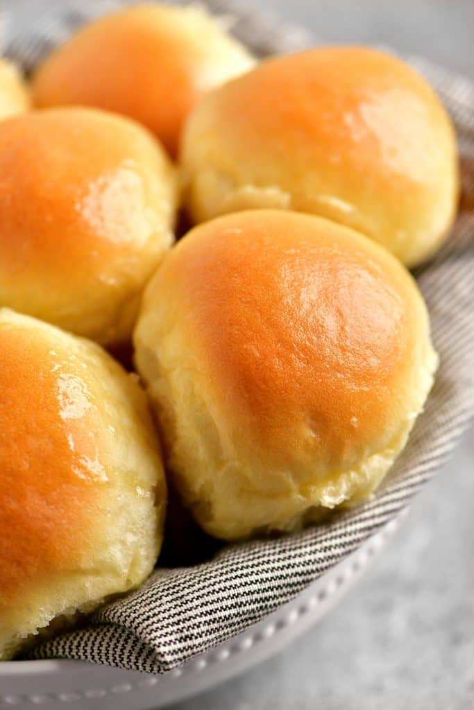 perfectly baked golden buns in a serving dish
