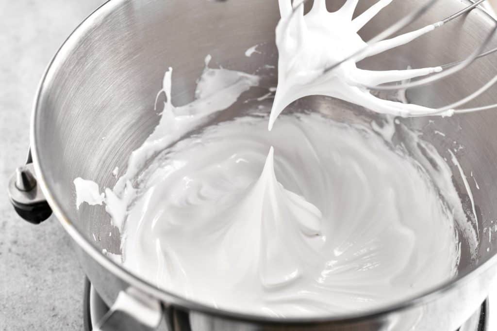 a close-up photo of the meringue mix in the mixer bowl