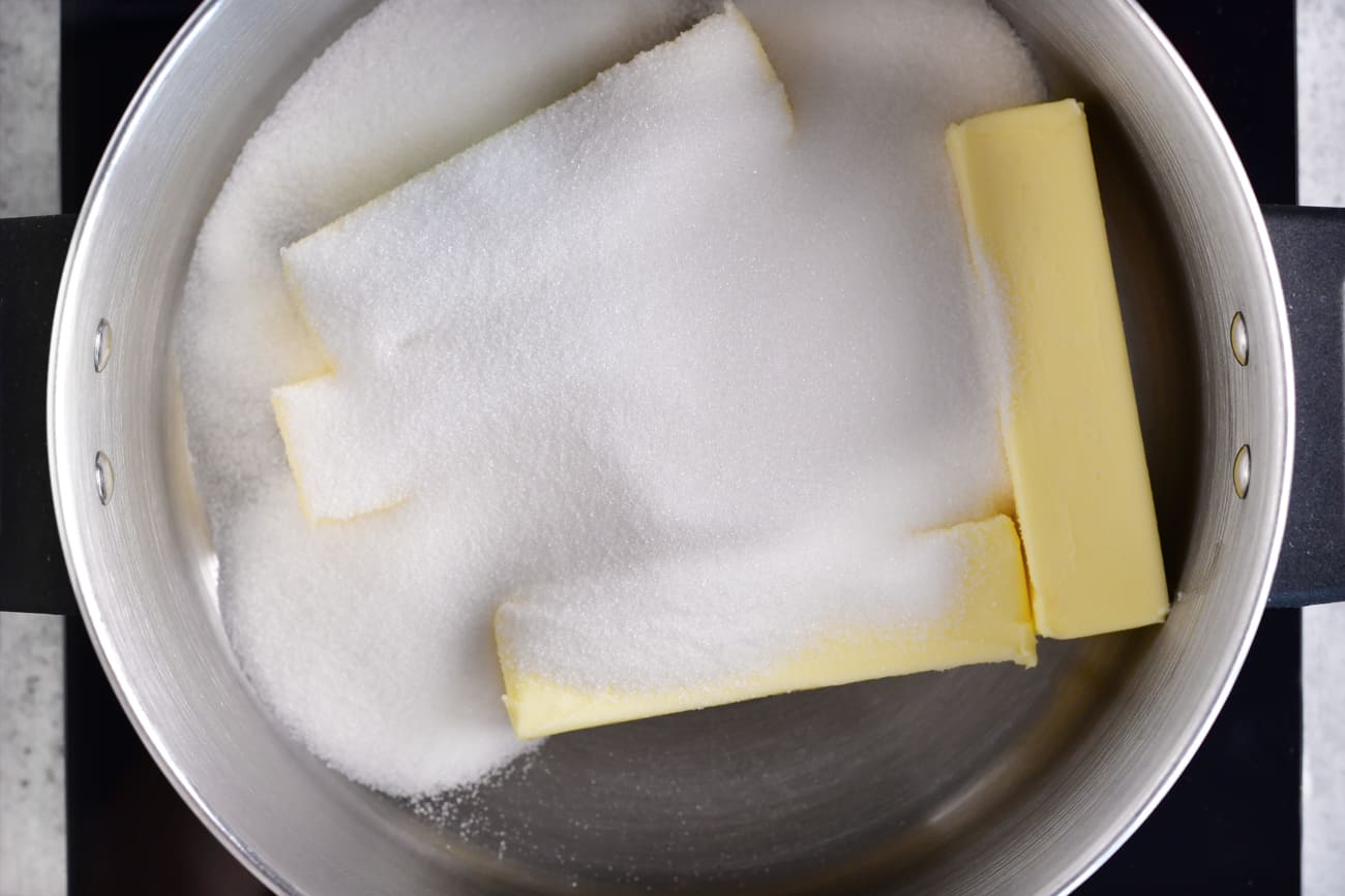 adding butter, sugar and water to the pot