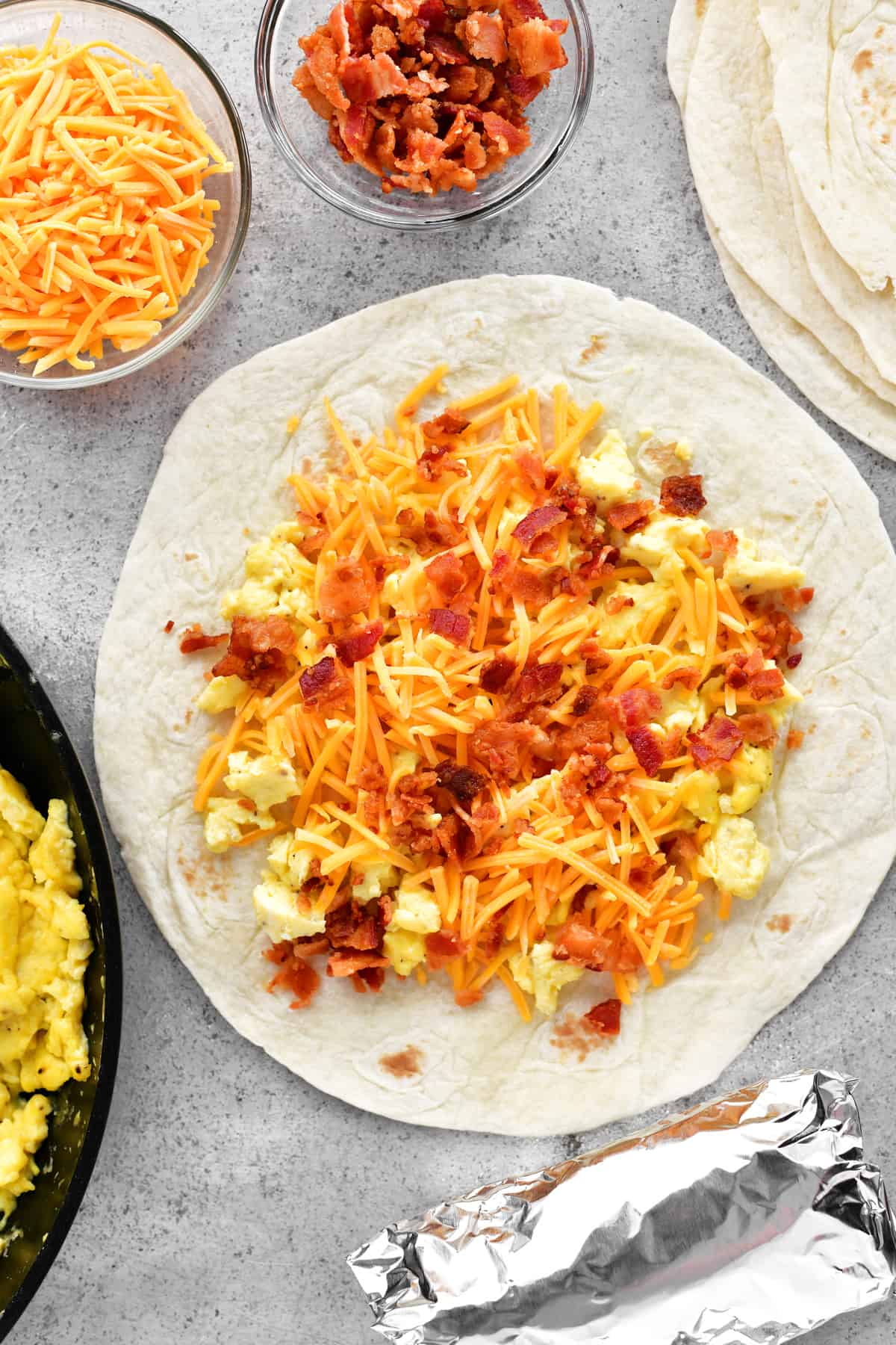 assembling a bacon egg and cheese breakfast burrito