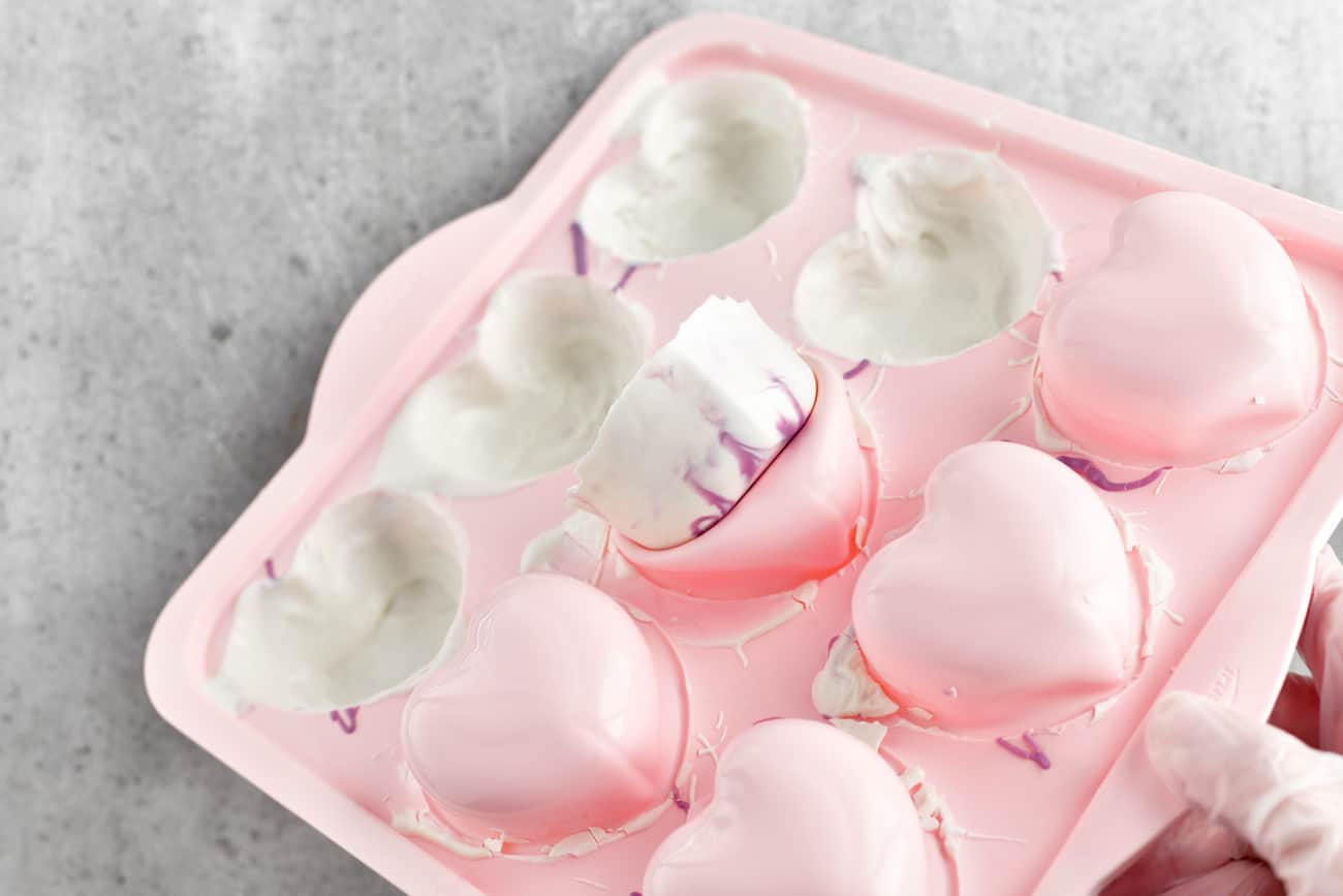 removing white chocolate hearts from a silicone mold