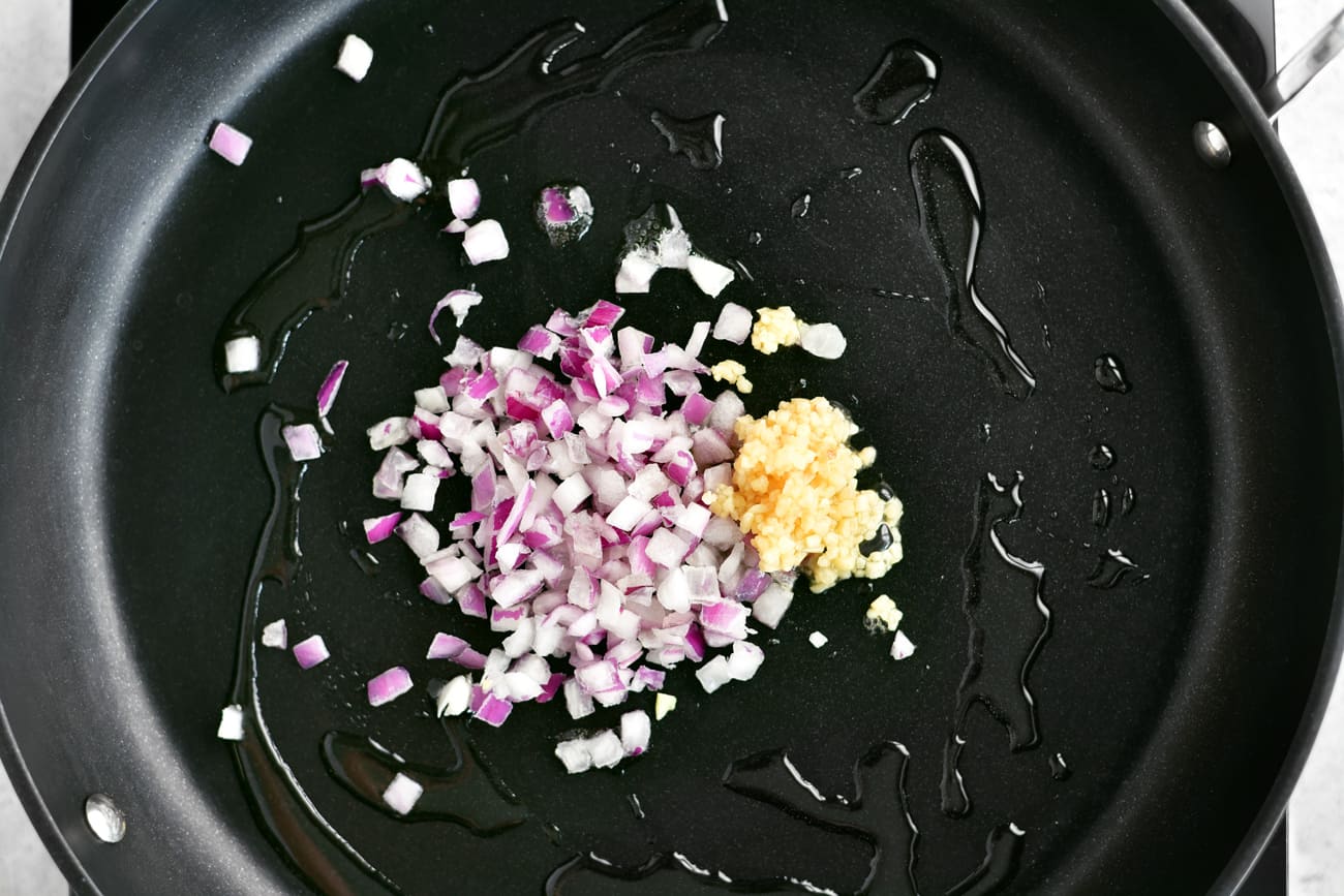 chopped onions and garlic in a frying pan