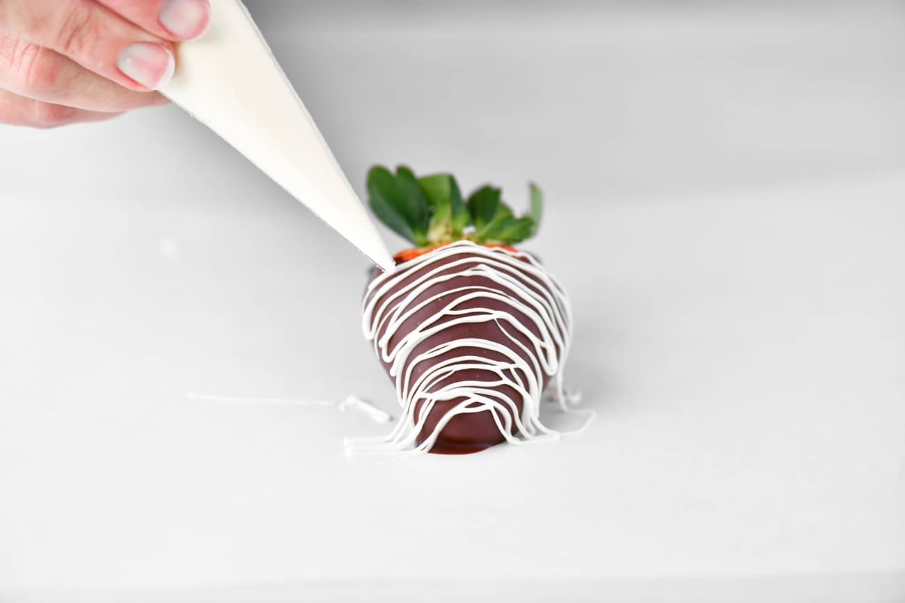 drizzle white chocolate on a chocolate covered strawberry